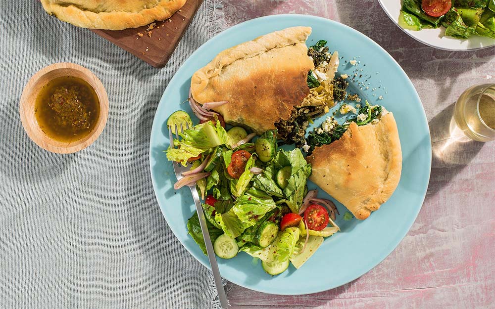 Greek-style Spanakopita Calzones with feta, spinach and a chopped salad, Customer Favourite